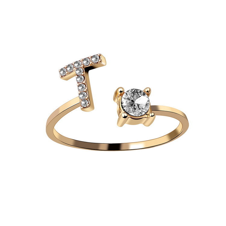 edenista gold-tone adjustable initial-letter ring with a crystal-studded T and a solitaire stone