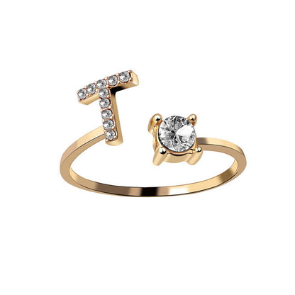 edenista gold-tone adjustable initial-letter ring with a crystal-studded T and a solitaire stone