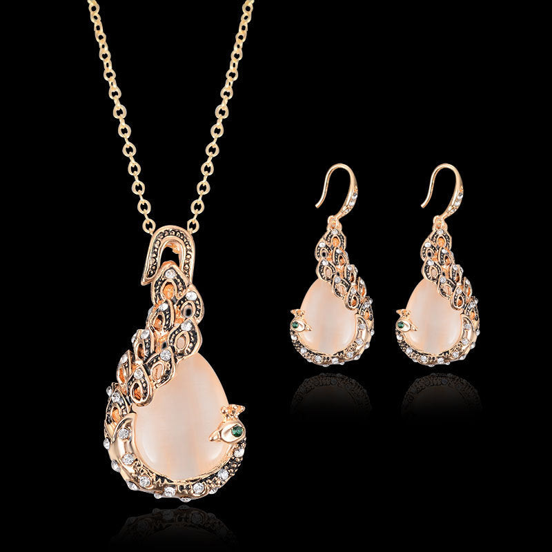 Bridal peacock gem necklace and earrings set in gold-tone with peach cabochons and clear crystals