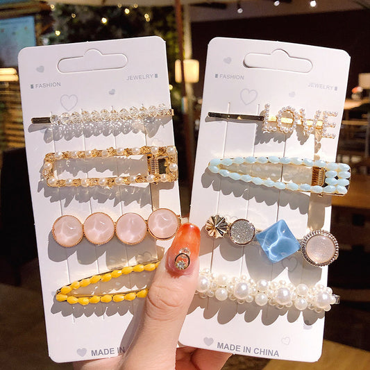 Girls' simple pearl clip set hair accessories on display cards; includes pearl-beaded hair clips and pastel stone pins.