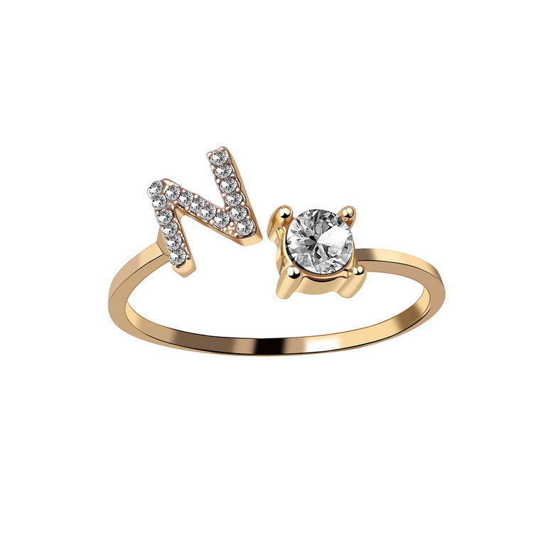 Adjustable gold ring featuring N initial with pave stones and a solitaire stone