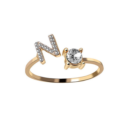 Adjustable gold ring featuring N initial with pave stones and a solitaire stone