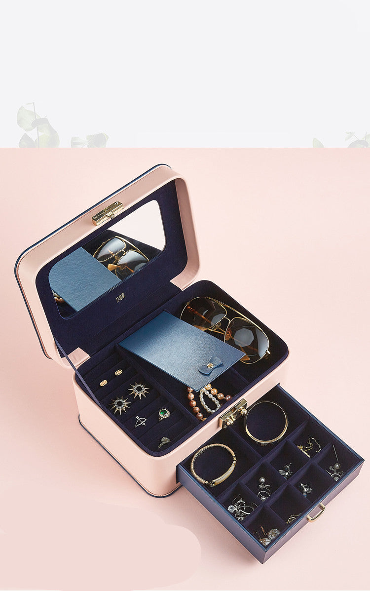 Jewelry storage box by Edenista, pink exterior with navy velvet interior and multiple compartments