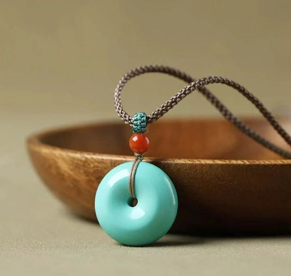 High Porcelain Turquoise Bread Ring Safety Buckle necklace with donut pendant on a braided cord