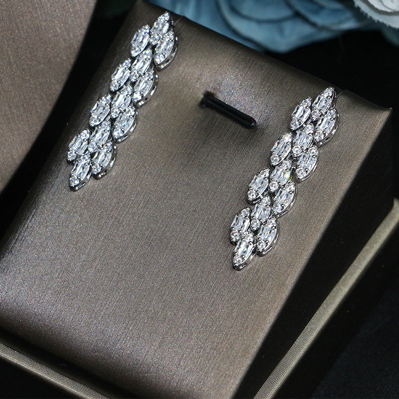 Bridal zircon earrings; silver-tone with clear crystals, two earrings displayed on a brown box
