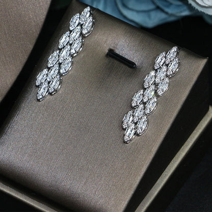 Bridal zircon earrings; silver-tone with clear crystals, two earrings displayed on a brown box