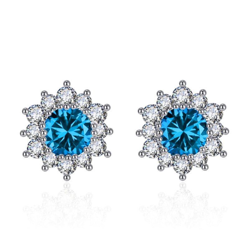 Snowflake stud earrings with blue center stones and clear crystal halo, pair