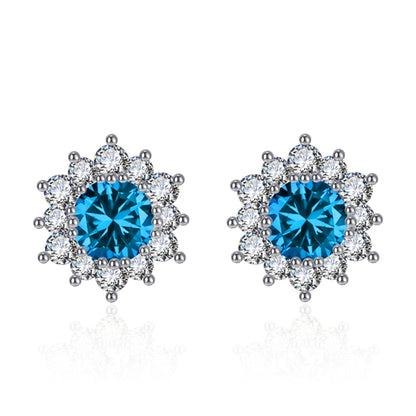Snowflake stud earrings with blue center stones and clear crystal halo, pair