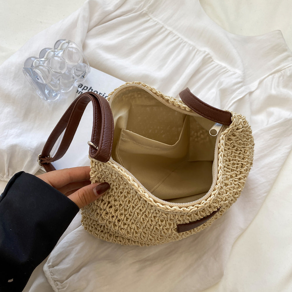 Niche Design Vacation Straw Tote Bag with natural straw body and brown leather handles.