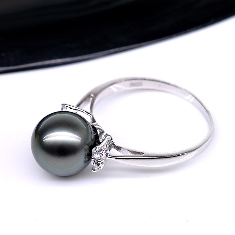 Natural Deep Sea Nanyang Pearl Ring with a silver band and dark gray pearl, diamond accents.