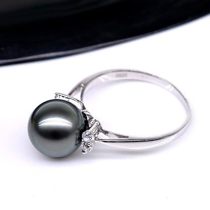 Natural Deep Sea Nanyang Pearl Ring with a silver band and dark gray pearl, diamond accents.