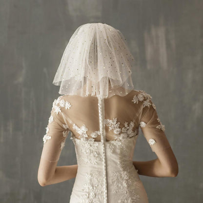 White yarn bridal multi-layer short veil, showcased over a lace wedding dress.