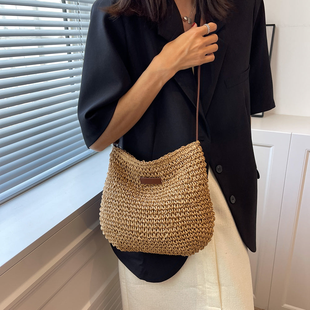 Niche Design vacation straw tote bag with brown leather strap in natural beige.