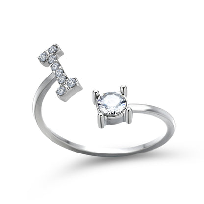 Adjustable silver-tone ring with pavé-set row of small clear stones on one end and a solitaire gemstone on the other