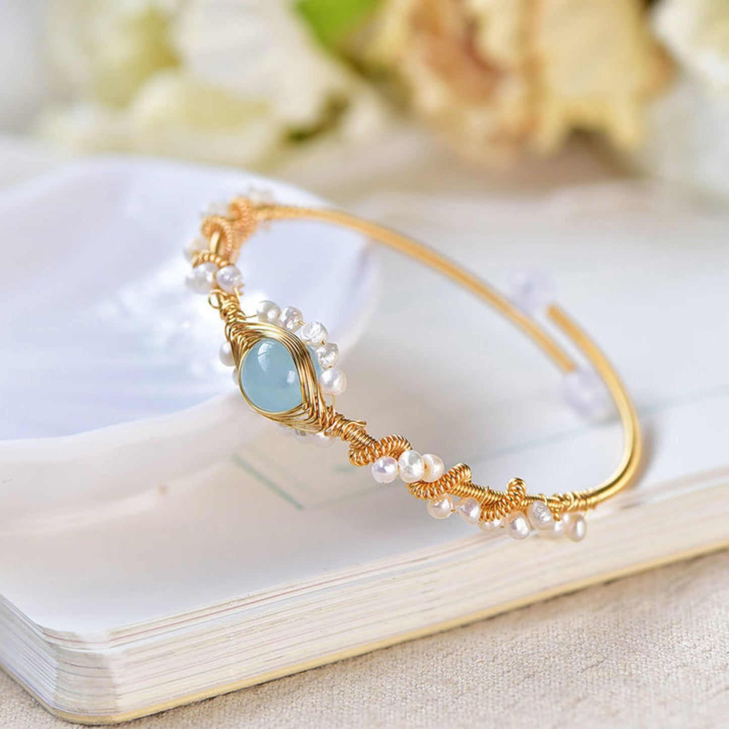 Pearl bracelet with gold wire braid and pale blue centerpiece, white pearl beads, CJ brand