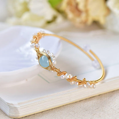 Pearl bracelet with gold wire braid and pale blue centerpiece, white pearl beads, CJ brand