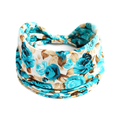 Yoga headband in teal floral print; absorbent bohemian fabric.