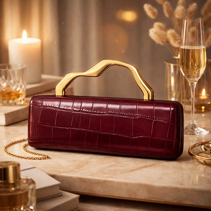 Luxury burgundy crocodile-pattern PU evening clutch by Edenista with gilded curved handle and gold chain.