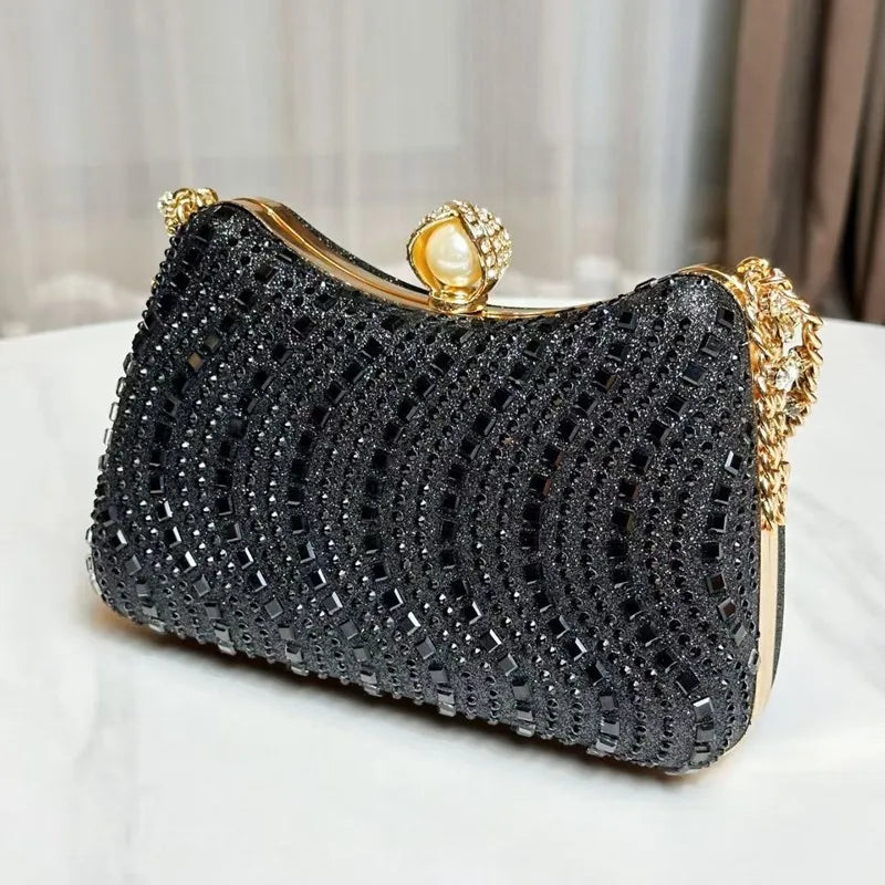 Black rhinestone inlay evening clutch with gold frame and pearl-accent clasp