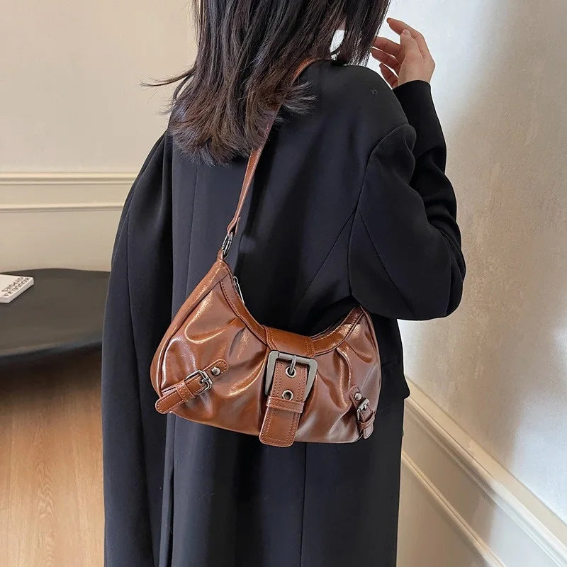 Hobo handbag in brown leather with front buckle accents and crossbody strap