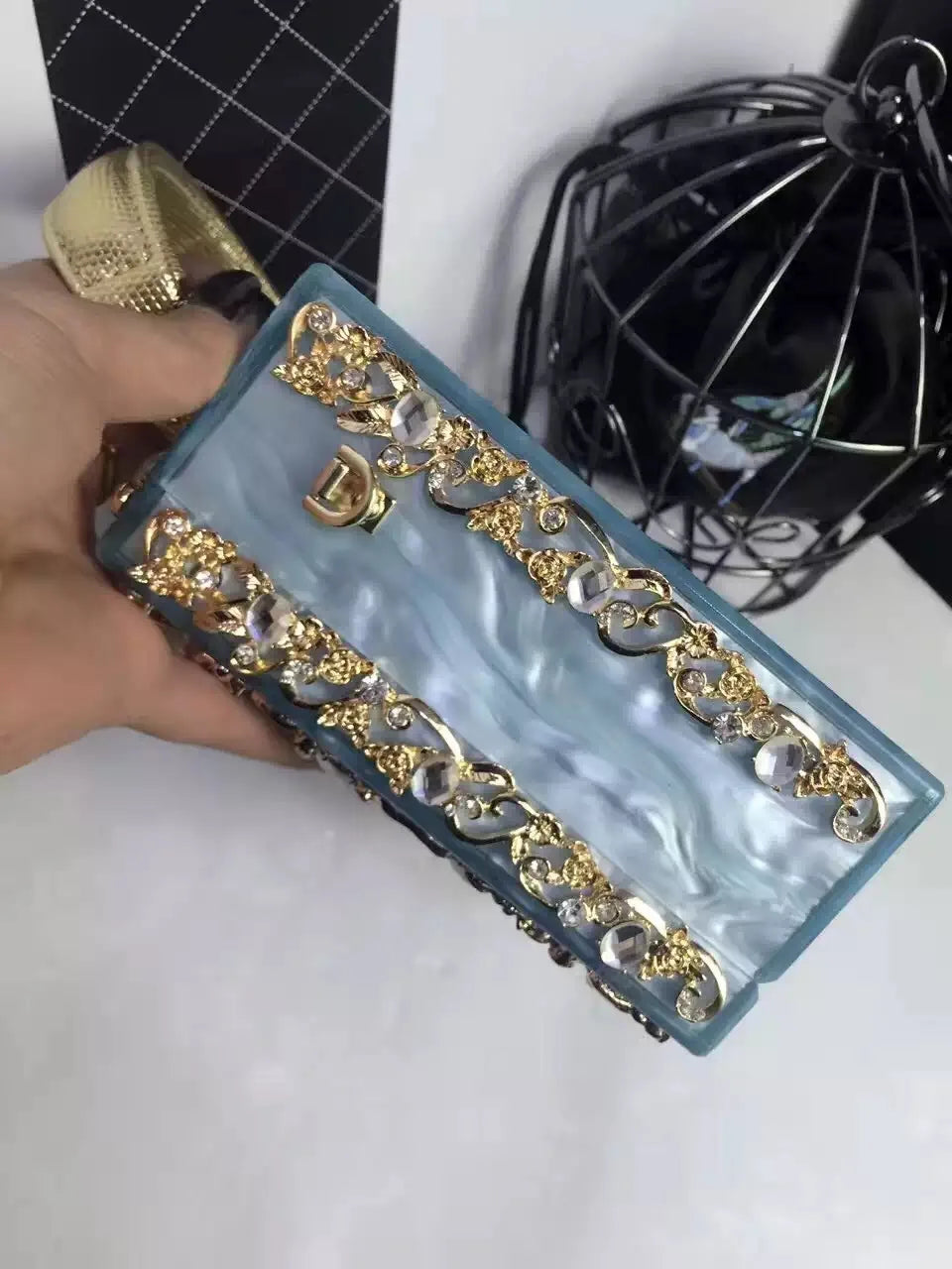 Acrylic evening bag by Edenista in blue with gold rhinestone trim