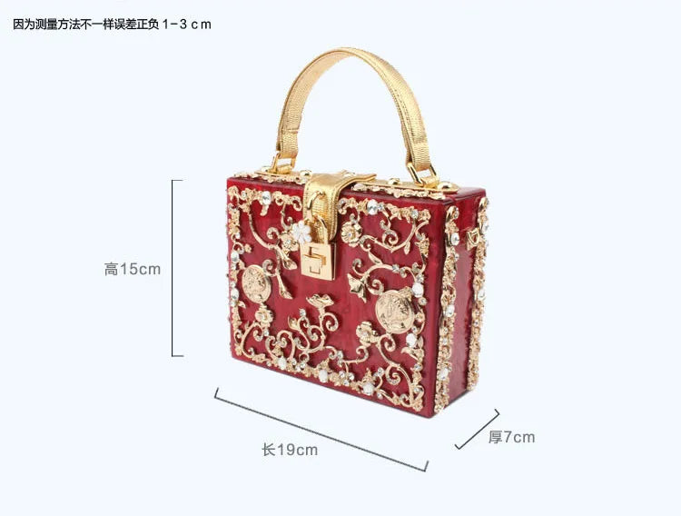Red acrylic evening bag with gold-tone filigree and rhinestones; gold handle, lock closure, 19x15x7 cm