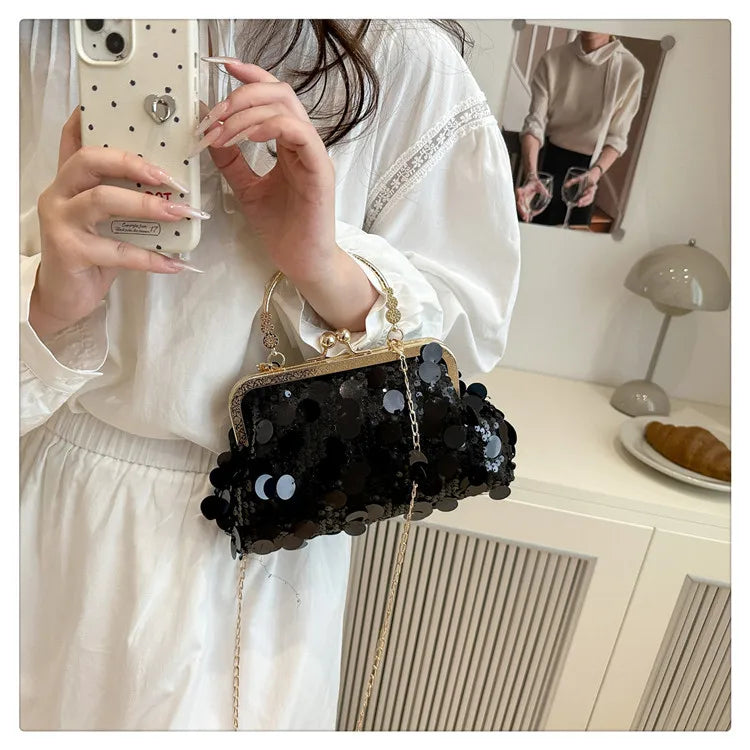 Black sequined evening shoulder bag with gold-tone frame and chain crossbody strap.