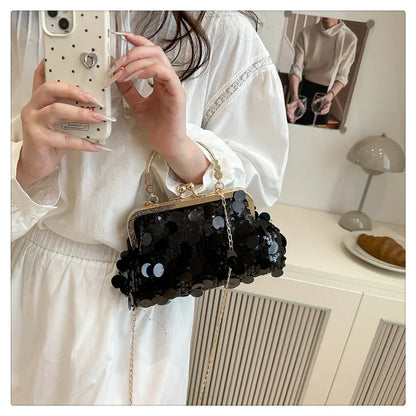Black sequined evening shoulder bag with gold-tone frame and chain crossbody strap.