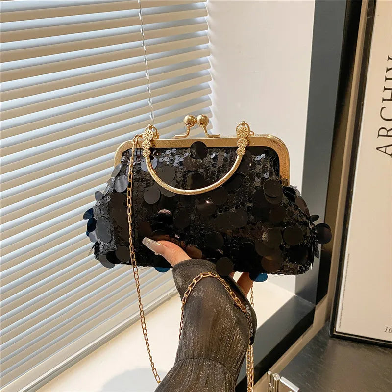Black sequined evening crossbody bag with gold-tone frame, clasp and chain strap