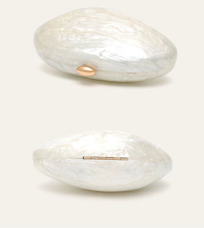 Shell-shaped acrylic clutch by Edenista, pearl-white with gold-tone oval clasp