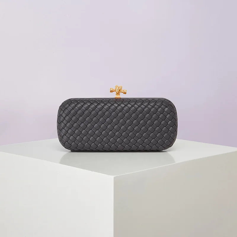 Crossbody black woven PU evening bag with gold-tone top clasp; boxy compact style
