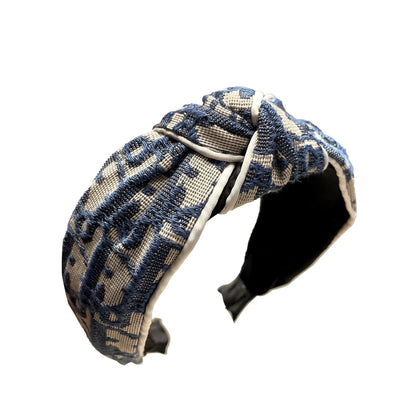 Edenista headband with blue and beige geometric woven fabric, knotted retro cowboy style for outdoor wear.