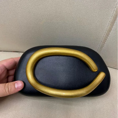Edenista black box clutch bag with a large gold-tone curved closure for evening wear.