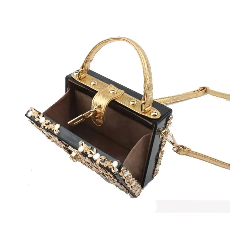 Edenista black acrylic evening bag with gold rhinestone embellished frame and detachable strap