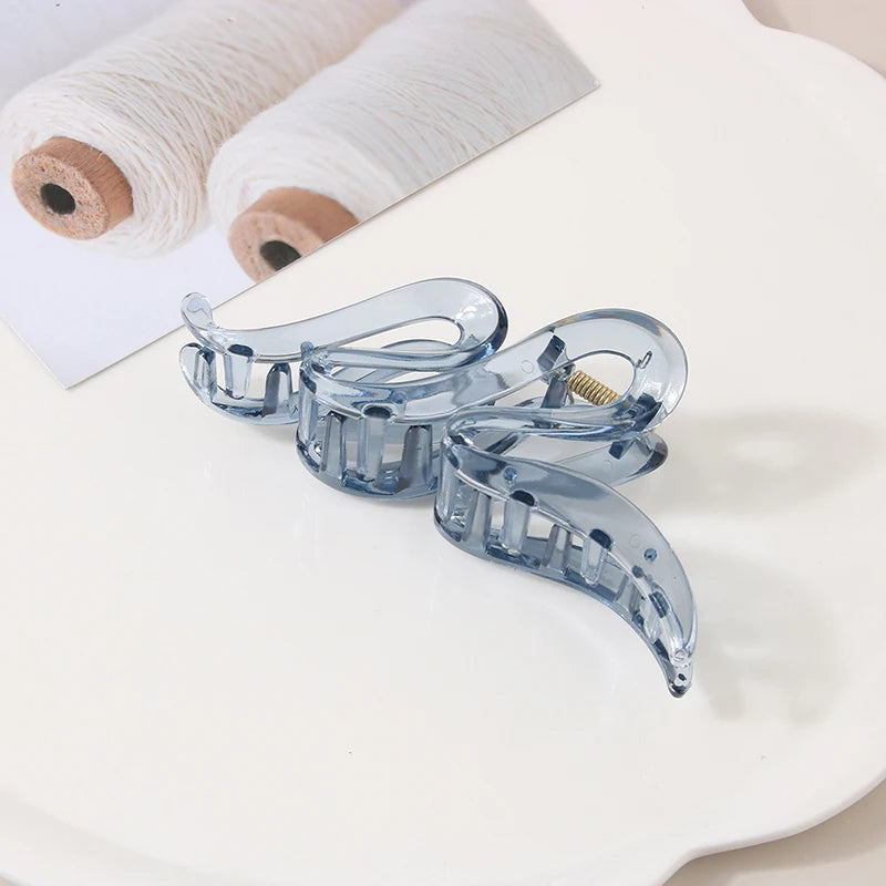 Hair claw clips set of 3 in translucent blue acrylic with geometric design.