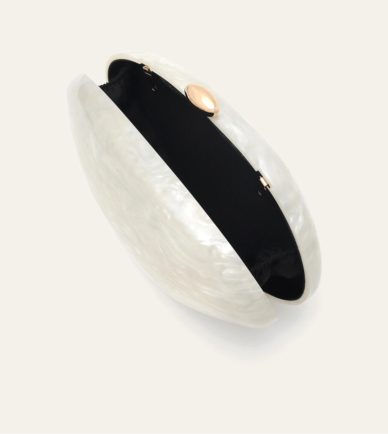 Edenista shell-shaped acrylic clutch, pearl-white with black interior and gold-tone round clasp.