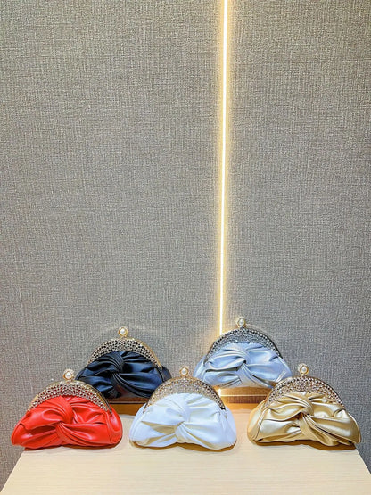 Satin prom clutches with crystal-embellished frames in red, black, light blue, white, and gold