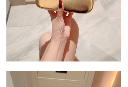 Gold metal-closure box clutch bag; women's evening purse with a rectangular silhouette.