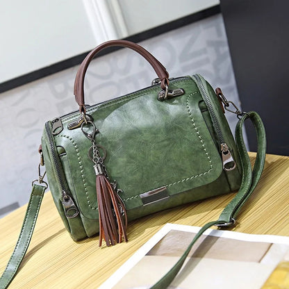 Green retro shoulder bag with brown top handles and floral tassel pendant, crossbody style