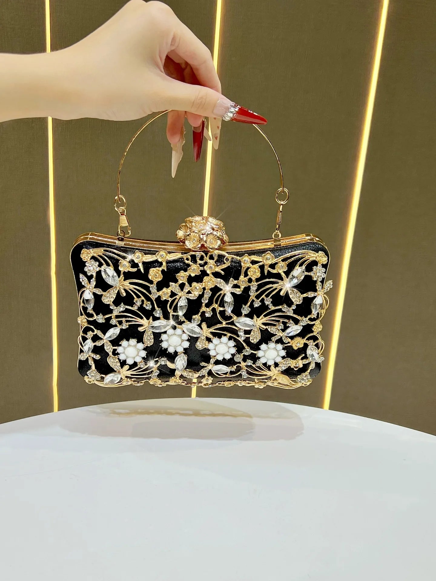 Diamond-embellished banquet bag in black velvet with gold floral embroidery, crystal accents, and a gold frame clasp