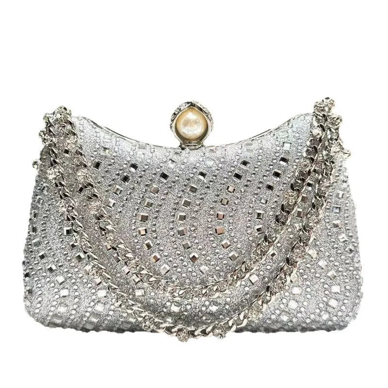 Silver rhinestone-embellished evening clutch with pearl clasp and chain strap