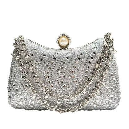 Silver rhinestone-embellished evening clutch with pearl clasp and chain strap