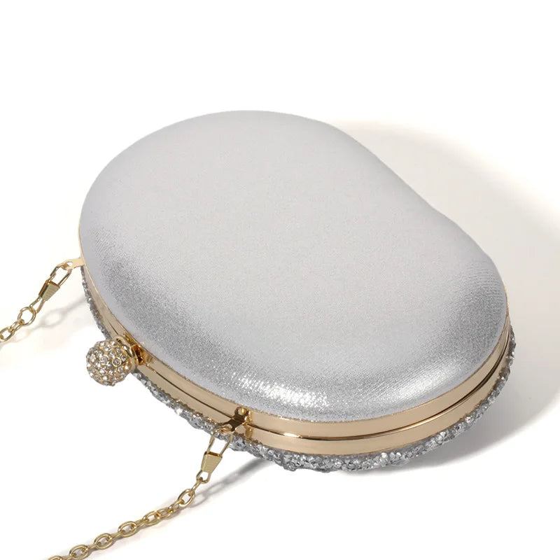Edenista glitter evening clutch with silver metallic body, gold frame, rhinestone trim and chain strap
