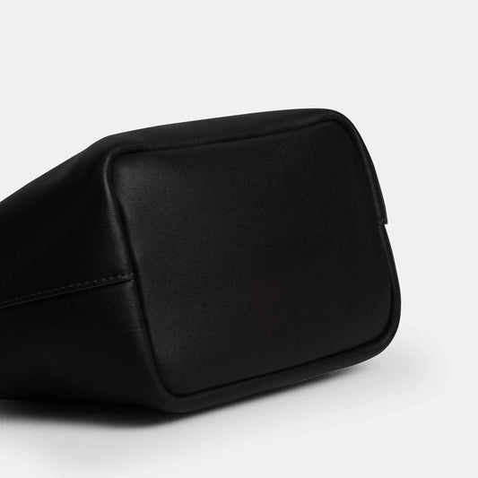 Edenista black microfibre leather kiss-lock top-handle clutch bag close-up corner