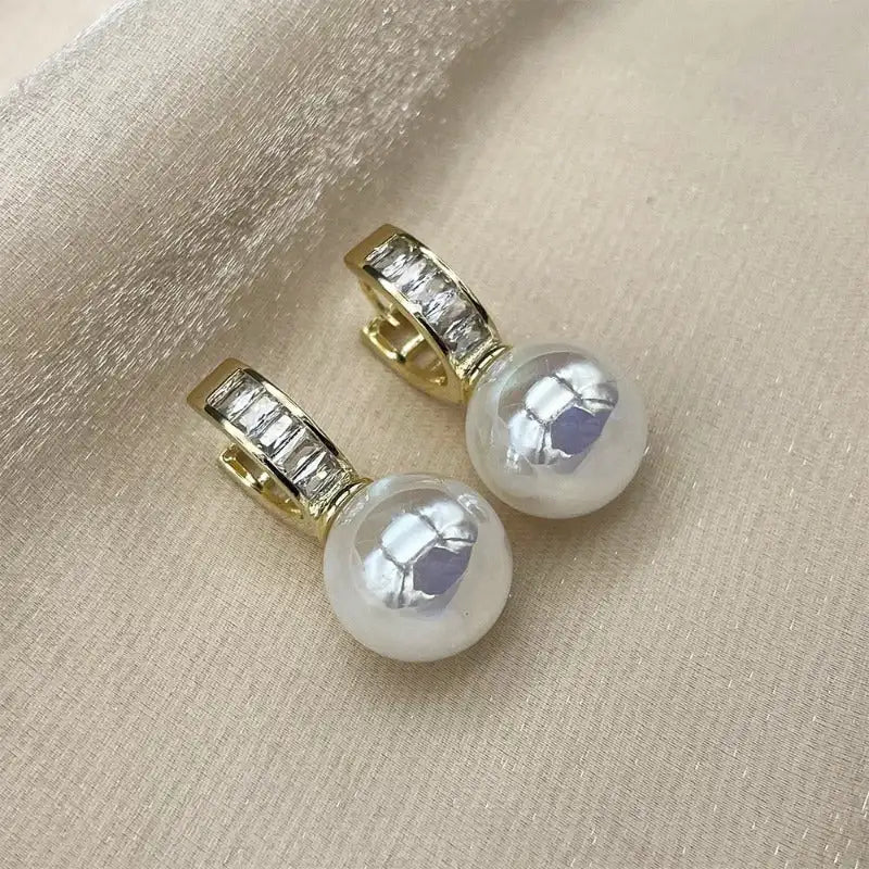 Pair of Edenista CAOSHI earrings with gold-tone setting, brilliant zirconia and simulated pearl drops