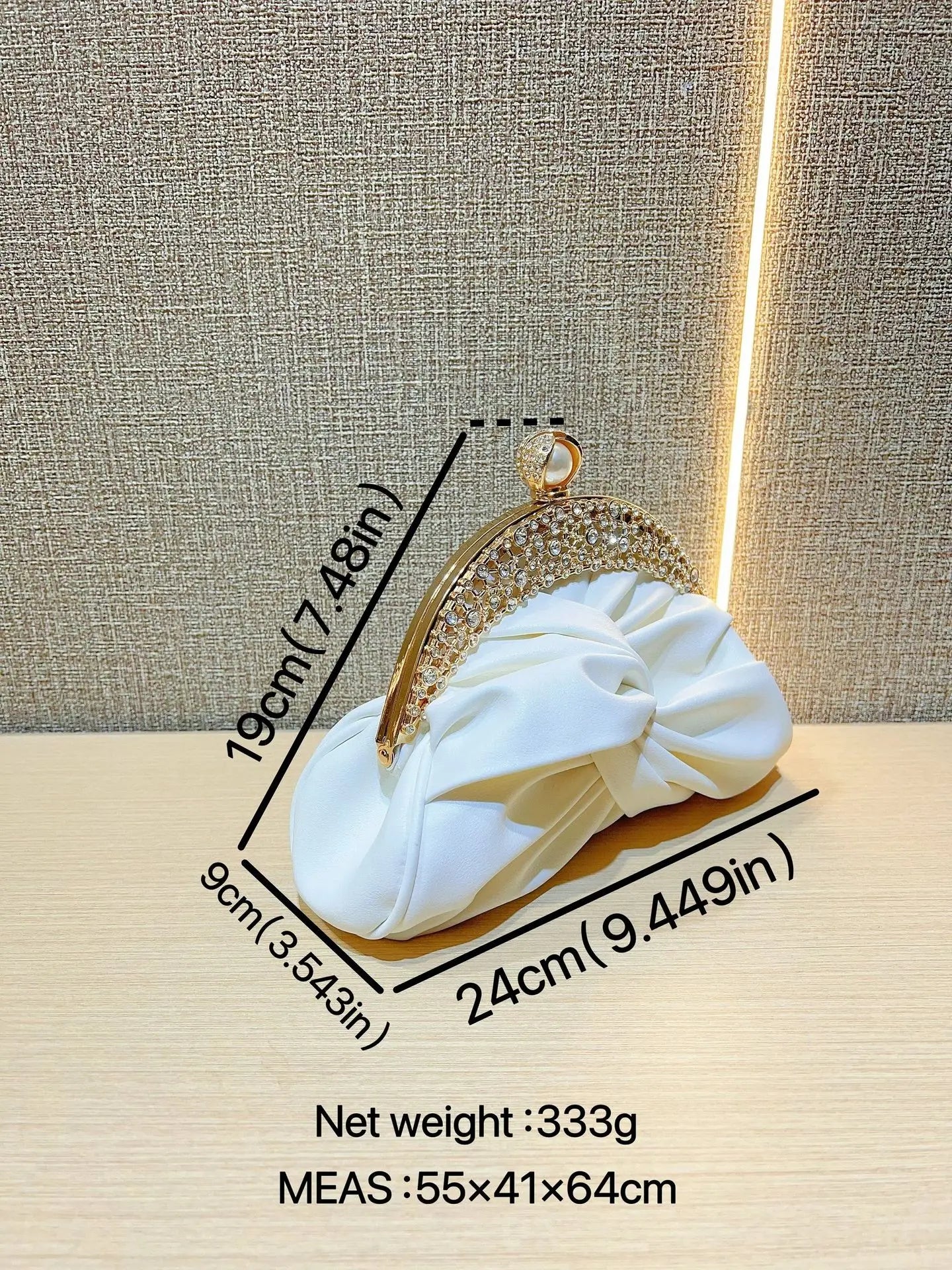 Fashion women's luxurious crystal-embellished gold-tone clutch with chain and white bow accent
