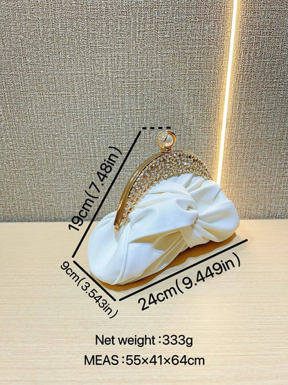 Fashion women's luxurious crystal-embellished gold-tone clutch with chain and white bow accent