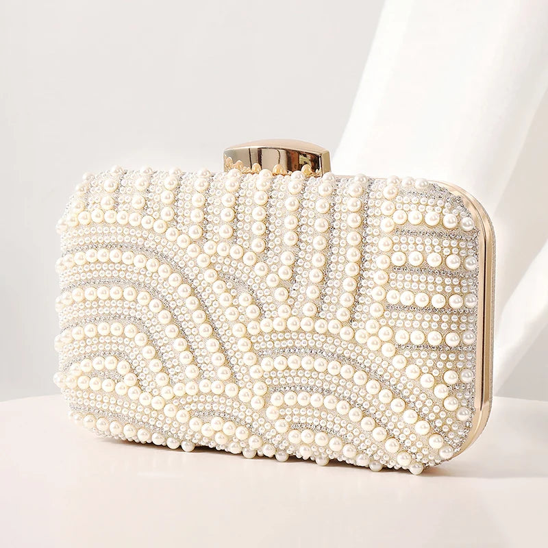 Pearl-embellished ivory evening clutch with long chain and beaded design.