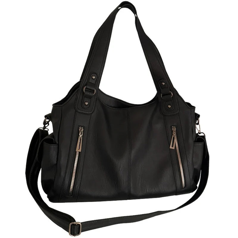 Women vintage edgy black leather tote bag by Edenista with top handles and crossbody strap