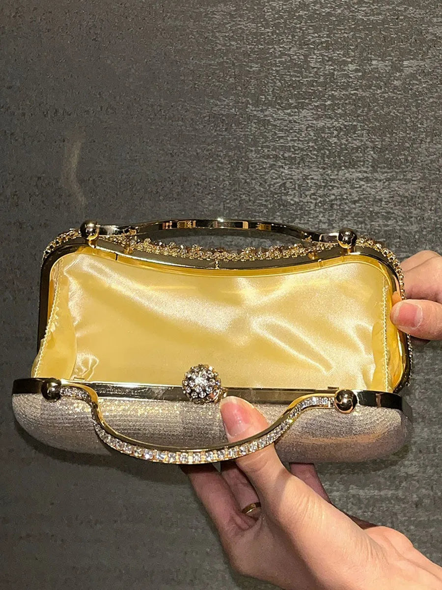 Diamond evening clutch with gold metallic frame, crystal rhinestones, and satin interior